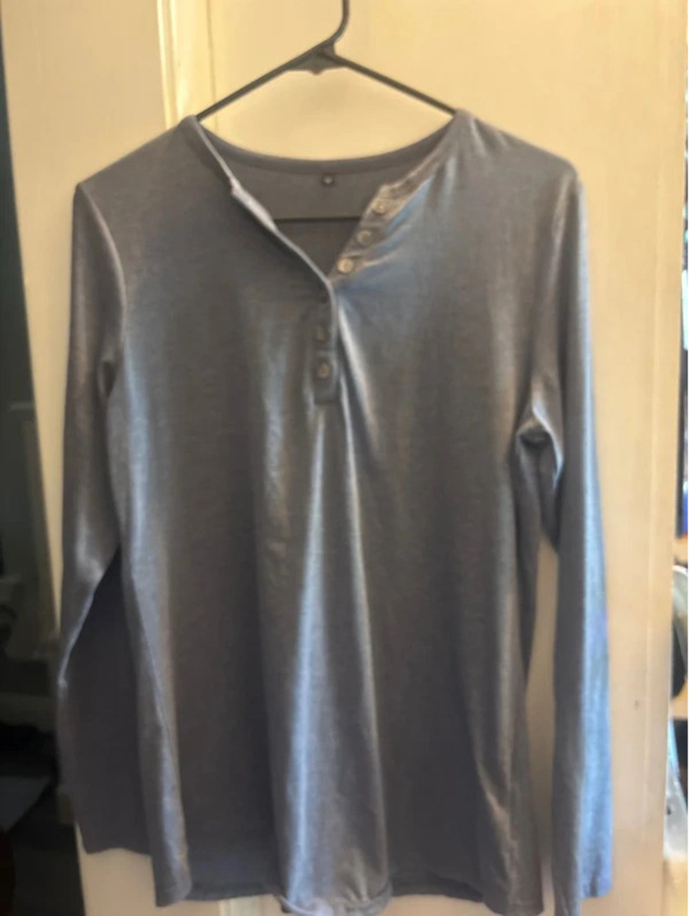 Long sleeved medium blue T-shirt with buttons